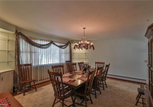 Formal Dining area with built-in corner cabinets and hardwood floors