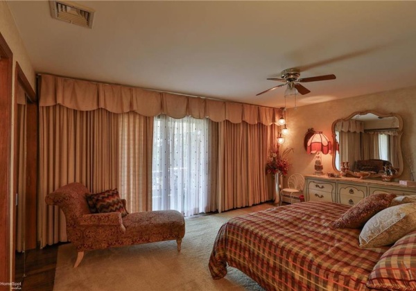 Primary bedroom with two closets - 1 4' deep step-in and 1 walk-in. Hardwood floors and slider to deck