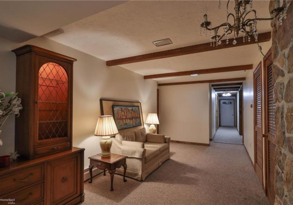 Lower level sitting area; door to the attached 2 bay garage visible.