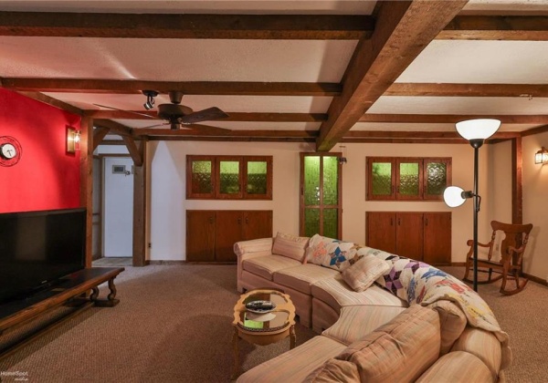 Lower level living room with built-in cabinets and back-lit panels