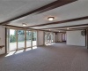 Sun room with entry to hot tub room, two full bathrooms and sauna. Multiple sliding glass doors to ground level patio.