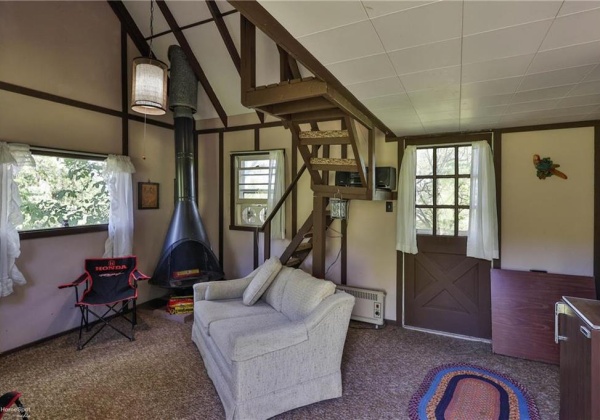 Living area of cabin with fireplace