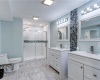 Extra large master bedroom suite bathroom, completely updated with new imported marble flooring, custom tiling, custom lighting, two separate siinking, bright new lighting, luxury multi-head shower system