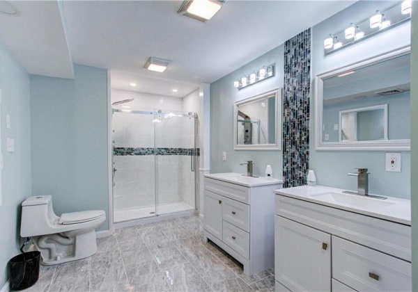 Extra large master bedroom suite bathroom, completely updated with new imported marble flooring, custom tiling, custom lighting, two separate siinking, bright new lighting, luxury multi-head shower system