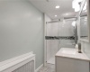 Second floor fully updated shared full bathroom with imported marble tile, custom ceramic tiling, intricate backsplash, luxury multi-head shower system