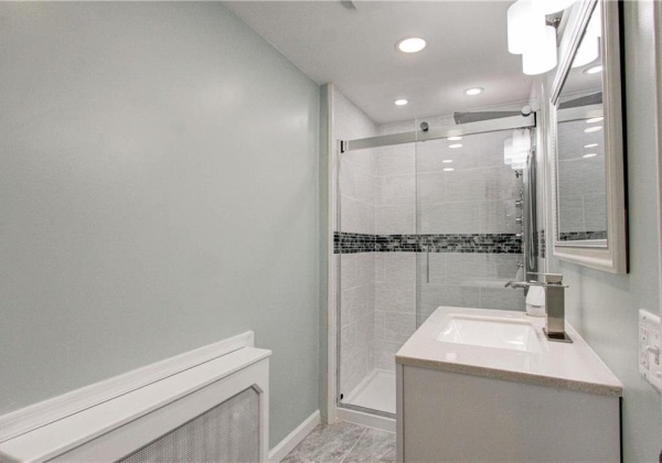 Second floor fully updated shared full bathroom with imported marble tile, custom ceramic tiling, intricate backsplash, luxury multi-head shower system