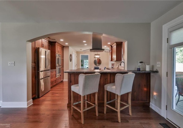 bar overhang seating area with view of Kitchen