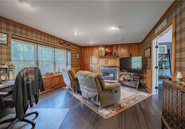 Warm Study with Native Wood Paneling & Wood Burning Fireplace Insert