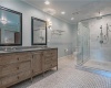 Beautiful Tiled floor, Glass Enclosed Shower with Rain Shower Head and Double Vanity