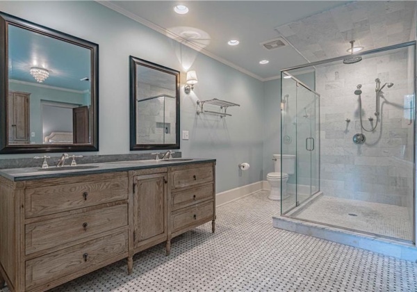 Beautiful Tiled floor, Glass Enclosed Shower with Rain Shower Head and Double Vanity