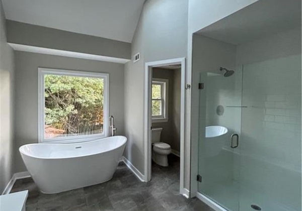 En suite master bathroom with skylight and cathedral ceilings