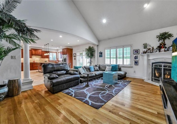 Great room with hardwood floors, corner fireplace and vaulted ceilings