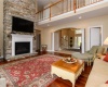 2 story great room with fireplace and doors to deck