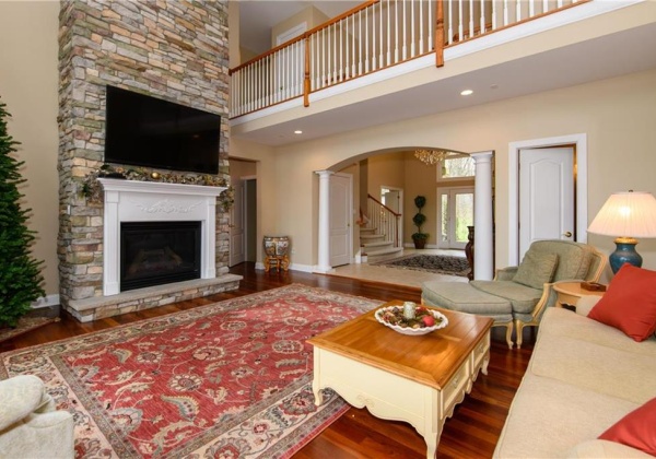 2 story great room with fireplace and doors to deck