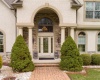 Front porch with pillars and professional landscaping