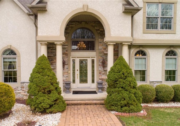 Front porch with pillars and professional landscaping