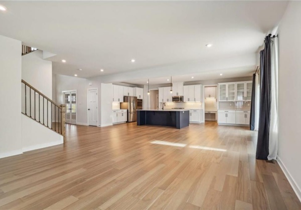 Open concept Family room view to kitchen and eating area accessible to outdoor covered porch.