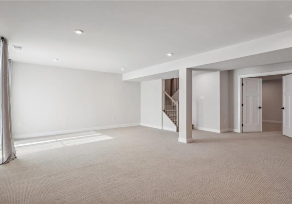 Family room in lower level with entrance to media room/exercise room via double doors.