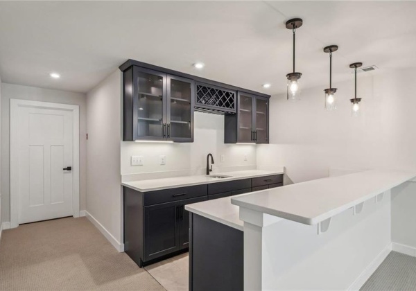 Lower level wet bar with built in wine refrigerator