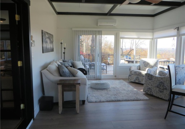 Sunroom with view of deck