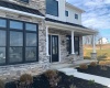 Covered porch with extra tall entry doors