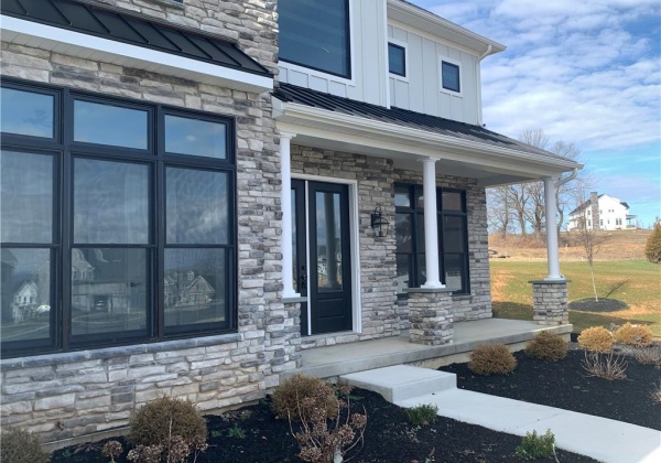 Covered porch with extra tall entry doors