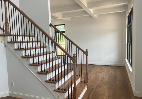 Looking into living room with transom windows and coffered ceiling