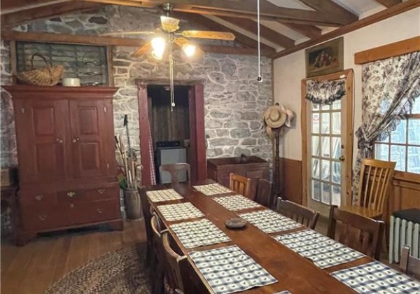 Dining room with stone wall from existing house.