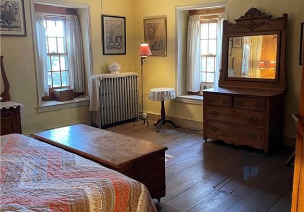 Main upstairs bedroom with 3 windows and fireplace.