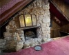 Stone fireplace in room above the kitchen.