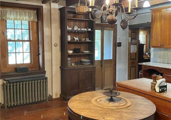 Kitchen with eat-in space and charming chandelier and exposed beams.