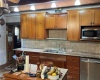 Kitchen with granite counter tops and tile back splash.