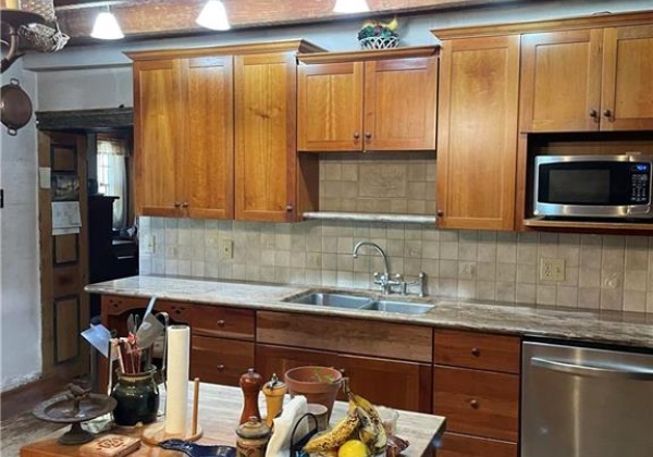 Kitchen with granite counter tops and tile back splash.