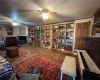 Living room with built-in bookshelves, wooden rolling library ladder and woodstove.