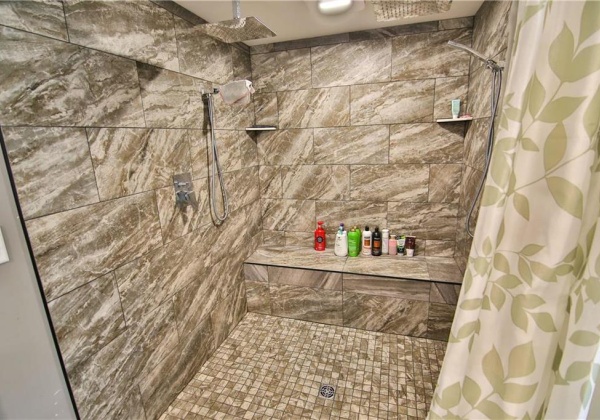 Shower for TWO! Stunning tile work surrounds you with multiple shower heads