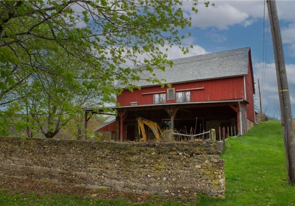 Original stone wall along the corral. Bank Barn is 35' x 50, with main level interior height of 27ft to rafters!