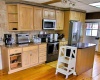 Updated kitchen features granite counters, SS appliances, fireplace and dining area