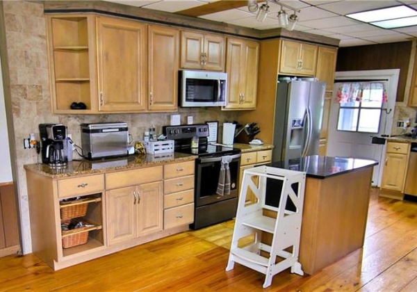 Updated kitchen features granite counters, SS appliances, fireplace and dining area